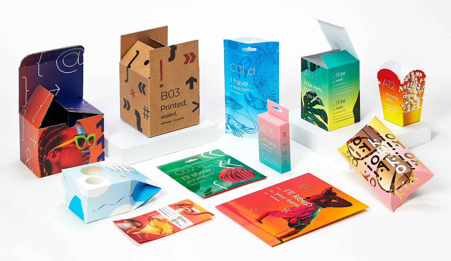 A collection of colorful printed packaging samples including boxes, labels, and cards.